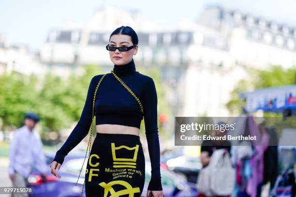 Guest wearssunglasses, a cropped bare belly turtleneck top, a skirt with yellow prints, outside Off-White, during Paris Fashion Week - Menswear...