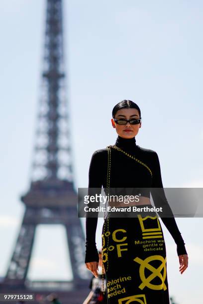 Guest wearssunglasses, a cropped bare belly turtleneck top, a skirt with yellow prints, outside Off-White, during Paris Fashion Week - Menswear...