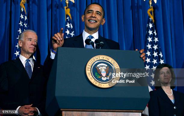 President Barack Obama speaks as Vice President Joe Biden and Ted Kennedy's widow Victoria Kennedy listen at a rally celebrating the final passage of...