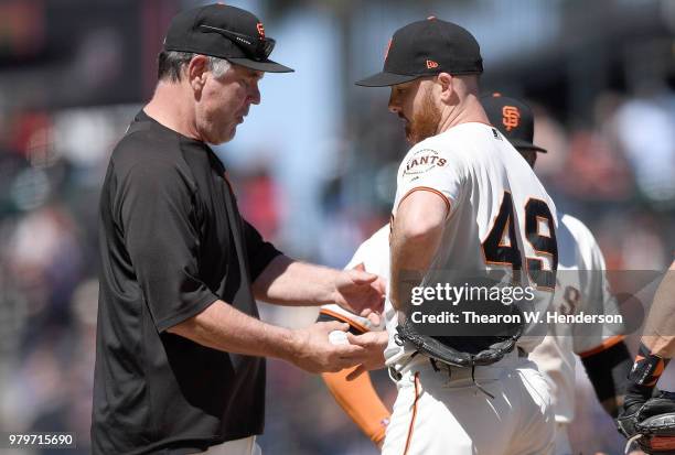 Manager Bruce Bochy of the San Francisco Giants takes the ball from pitcher Sam Dyson taking Dyson out of the game against the Miami Marlins in the...