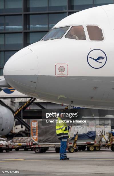 March 2018, Germany, Frankfurt: Sabrina Boock, in charge of ground handling operations, waits for the departure of an Airbus A 321 passenger aircraft...