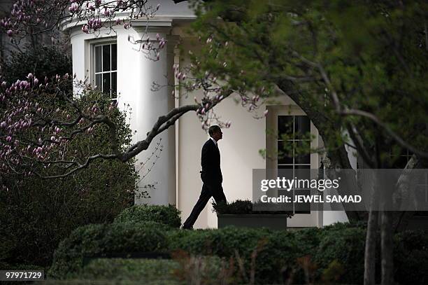 President Barack Obama walks to the Oval Office upon returning at the White House after speaking at a rally celebrating the passage and signing into...