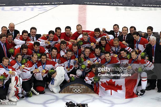 Team Canada poses for a team photo with their gold medals after winning the ice hockey men's gold medal game between USA and Canada on day 17 of the...