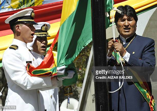 Bolivian President Evo Morales hoists the national flag next to Bolivia's national hero monument Eduardo Avaroa on March 23, 2010 during the 131...