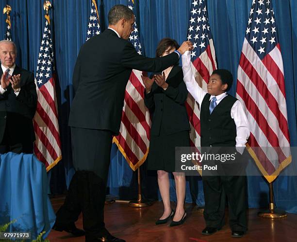 President Barack Obama gives a high five to Marcelas Owens, Seatlle, WA. As Vice President Joe Biden and Ted Kennedy's widow Victoria Kennedy watch...