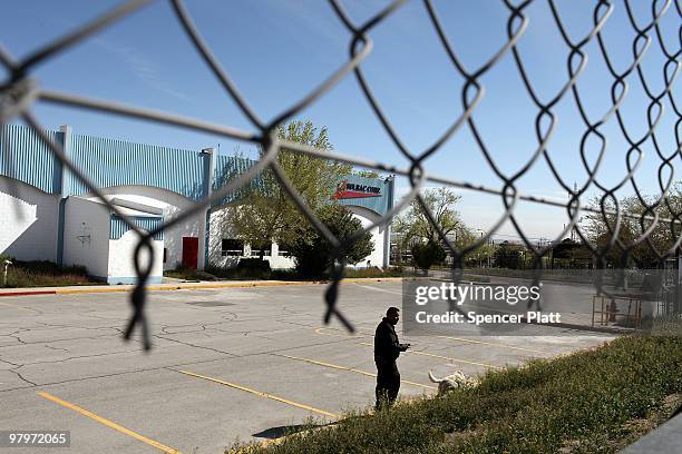 Security guard waits in front of a closed maquiladora, or factory, on March 23, 2010 in Juarez, Mexico. Secretary of State Hillary Rodham Clinton,...