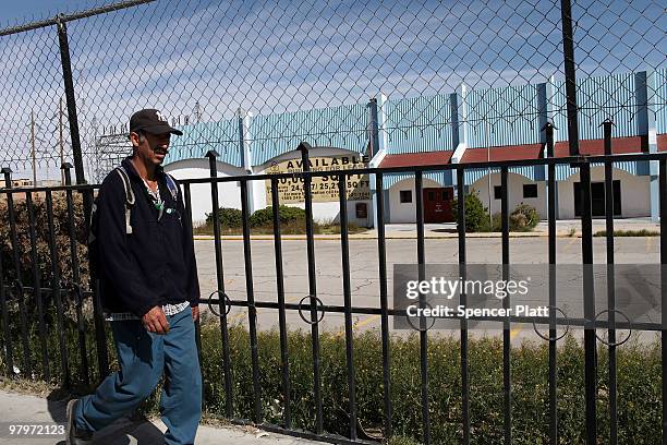 Man walks by a closed maquiladora, or factory, on March 23, 2010 in Juarez, Mexico. Secretary of State Hillary Rodham Clinton, Defense Secretary...