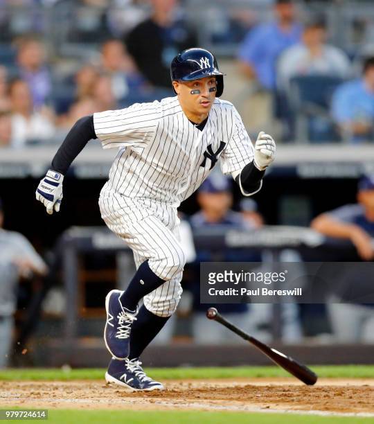 Ronald Torreyes of the New York Yankees drops his bat and runs out a grounder in an MLB baseball game against the Tampa Bay Rays on June 14, 2018 at...