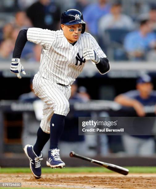 Ronald Torreyes of the New York Yankees drops his bat and runs out a grounder in an MLB baseball game against the Tampa Bay Rays on June 14, 2018 at...