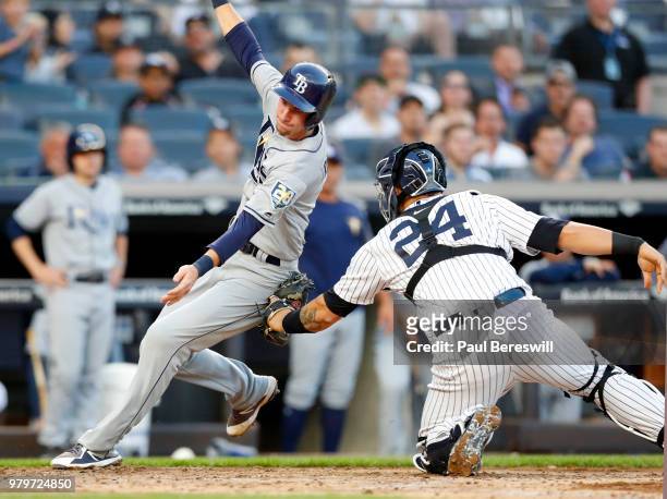 Catcher Gary Sanchez of the New York Yankees tags out Matt Duffy of the Tampa Bay Rays trying to score on a hit by Wilson Ramos in an MLB baseball...