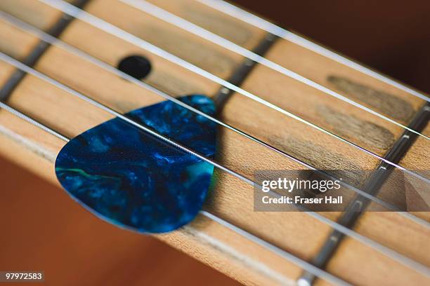 guitar strings and plectrum - guitar pick stock pictures, royalty-free photos & images