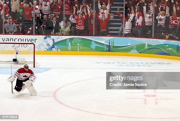 Goaltender Roberto Luongo of Canada skates from his net toward his teammates to celebrate after the ice hockey men's gold medal game between USA and...