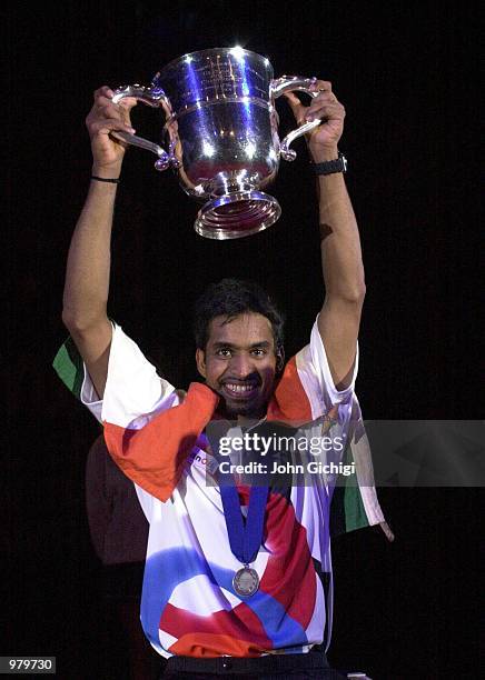 Pullela Gopichand of India celebrates with the trophy after winning the Mens Singles title at the Yonex All England Championships in Birmingham....