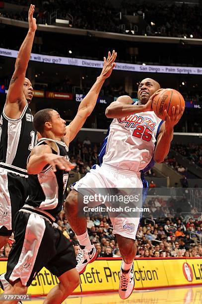 Mardy Collins of the Los Angeles Clippers goes to the basket against George Hill and Keith Bogans of the San Antonio Spurs during the game on...