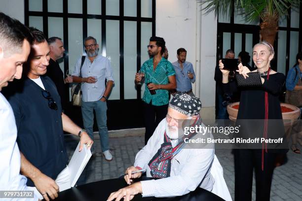 Bruce Weber and Carla Sozzani attend photographer Bruce Weber signs the book "Azzedine, Bruce and Joe" at Galerie Azzedine Alaia on June 20, 2018 in...