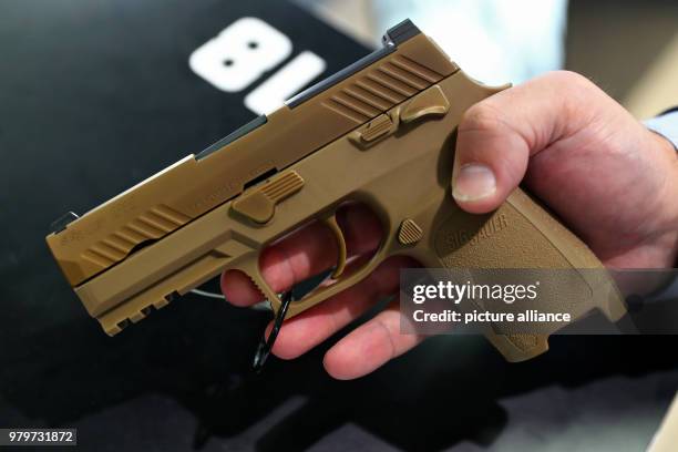 March 2018, Germany, Nuremberg: The M18 handgun by Sig Sauer, which the American army is equipped with, is exhibited at the "Enforce Tac" trade fair...