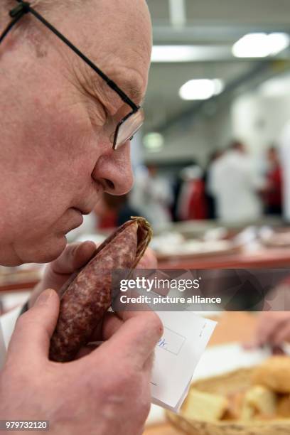 March 2018, Germany, Kassel: Tester Michael Rickert smelling with closed eyes a Ahle wurst . The testers are searching for the best North Hessian...