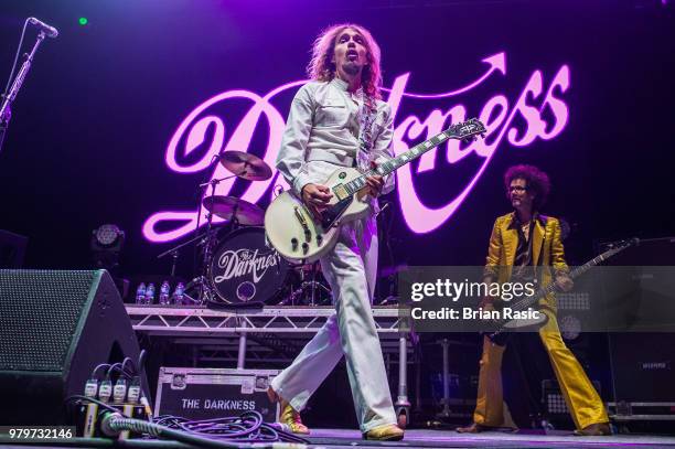 Justin Hawkins and Frankie Poullain of The Darkness perform live on stage at Wembley Arena on June 20, 2018 in London, England.