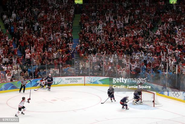 Sidney Crosby of Canada raises his arms to celebrate after scoring the game-winning goal in overtime against Ryan Miller of USA in the ice hockey...
