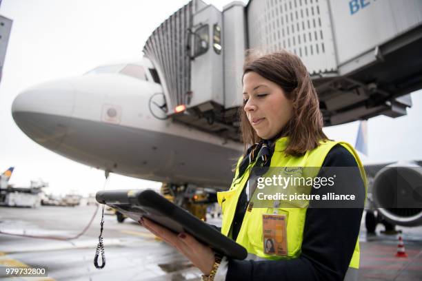 Ramp manager Christiana Schultheis monitors the loading of the Lufthansa Airbus A 321 before its flight to Berlin, in Frankfurt, Germany, 08 March...