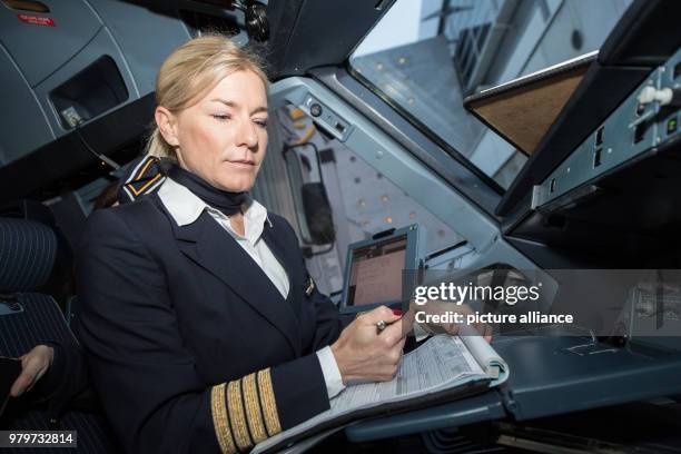 Pilot Riccarda Tammerle makes some last minute checks aboard the Lufthansa Airbus A 321 before its flight to Berlin, in Frankfurt, Germany, 08 March...