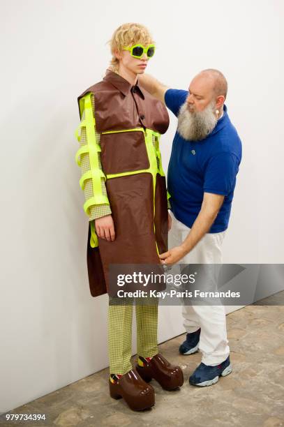 Designer Walter Van Beirendonck prepares a model backstage prior to the Walter Van Beirendonck Menswear Spring Summer 2019 show as part of Paris...