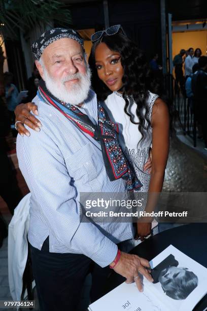 Bruce Weber signs the book for model Naomi Campbell during photographer Bruce Weber signs the book "Azzedine, Bruce and Joe" at Galerie Azzedine...