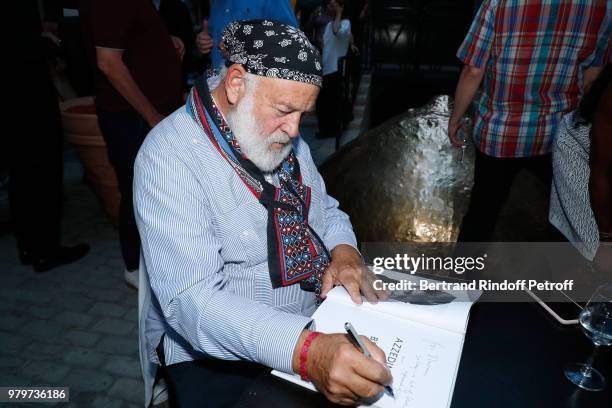 Bruce Weber signs the book for model Naomi Campbell during photographer Bruce Weber signs the book "Azzedine, Bruce and Joe" at Galerie Azzedine...