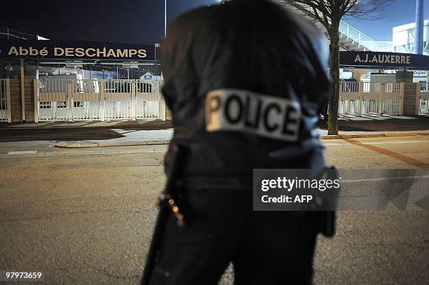 Policeman stands guard in front of the Abbe Deschamps stadium in Auxerre, on 23 March before the French Cup football match Auxerre vs PSG. The match...