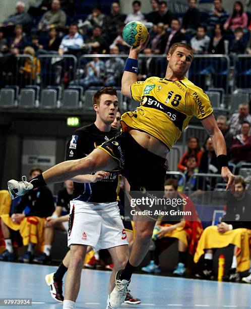 Bjarte Myrhol of Rhein-Neckar Loewen is challenged by Bobby Schagen of Dormagen during the Toyota Bundesliga match between Rhein-Neckar Loewen and...