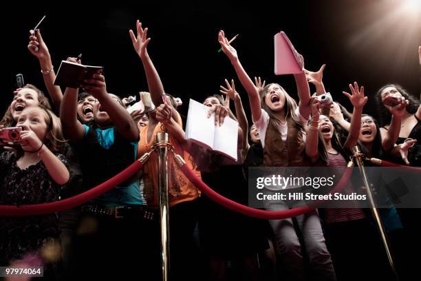 screaming fans on the red carpet - kids mess carpet stock pictures, royalty-free photos & images