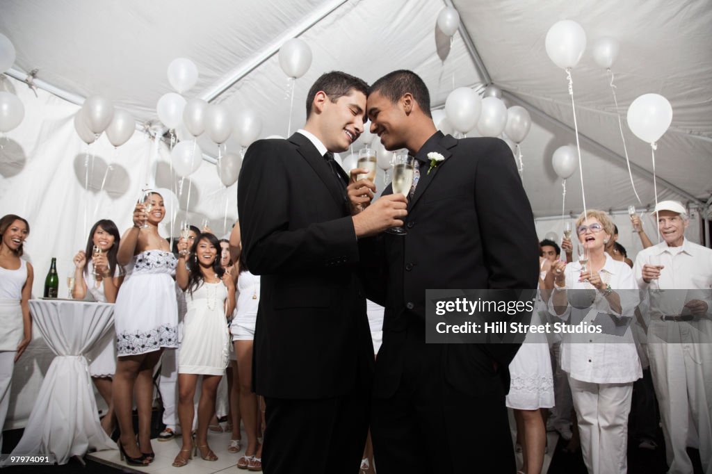 Gay married couple enjoying wedding reception