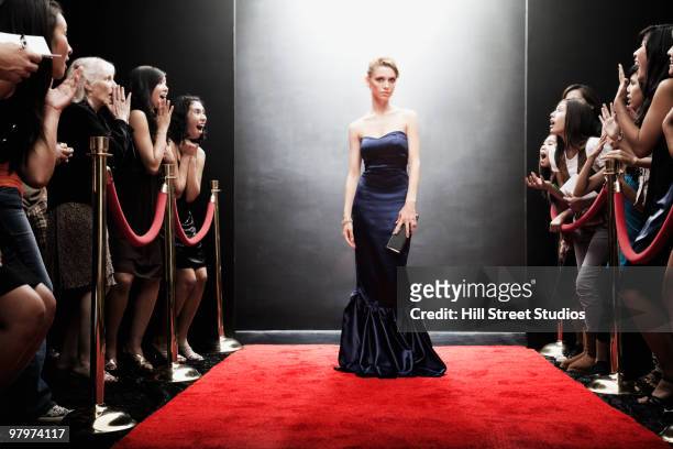 elegant caucasian woman posing on red carpet - red carpet event stock pictures, royalty-free photos & images