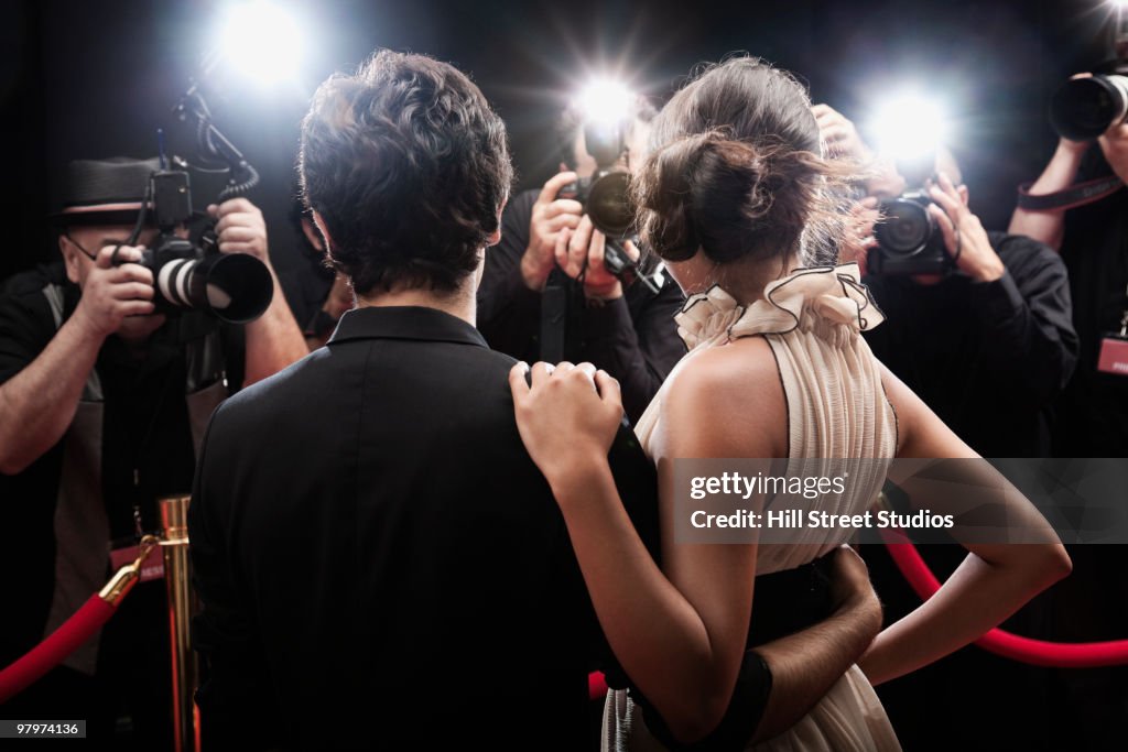 Celebrities posing on red carpet