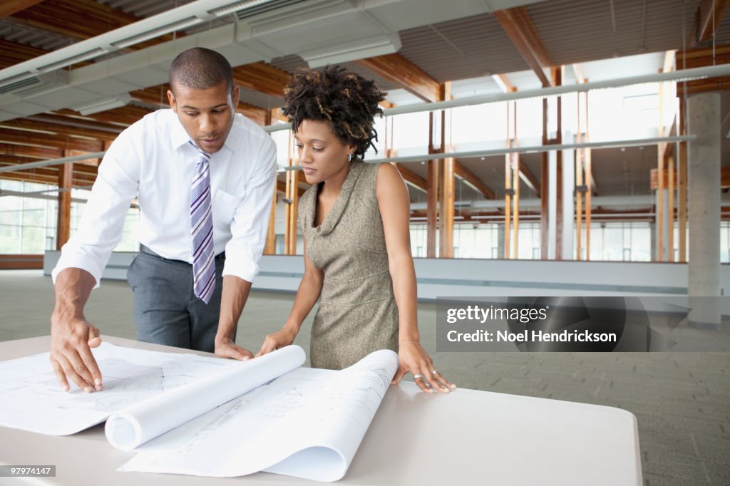 Business people looking at blueprints