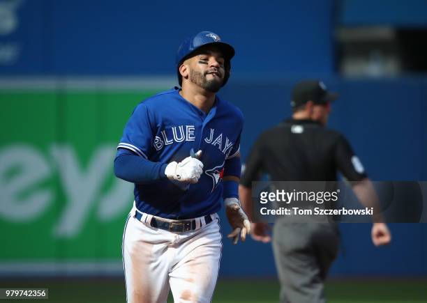 Devon Travis of the Toronto Blue Jays circles the bases after hitting a two-run home run in the fifth inning during MLB game action against the...