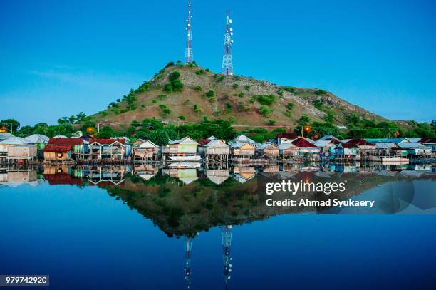 the reflection of poto tano village - poto poto district stock pictures, royalty-free photos & images