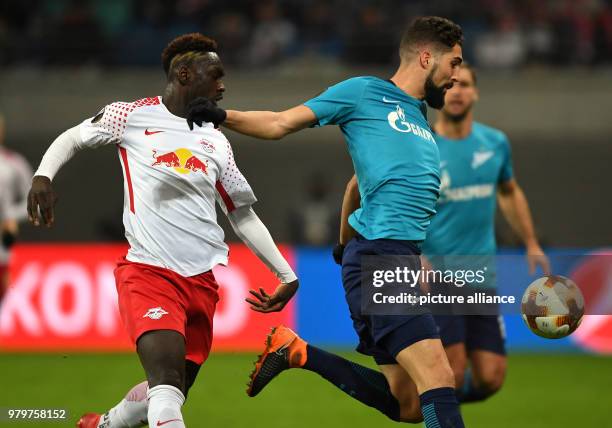 Leipzig's Jean-Kévin Augustin and St. Petersburg's Miha Mevlja vie for the ball during the UEFA Europa League round of 16 first leg soccer match...