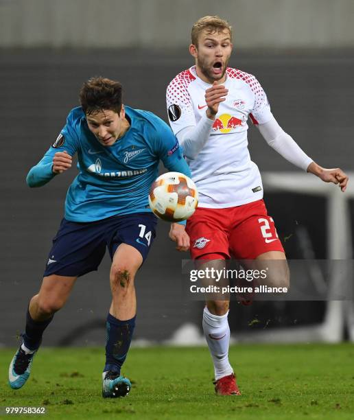 Leipzig's Konrad Laimer and St. Petersburg's Daler Kuzyaev battle for the ball during the UEFA Europa League round of 16 first leg soccer match...