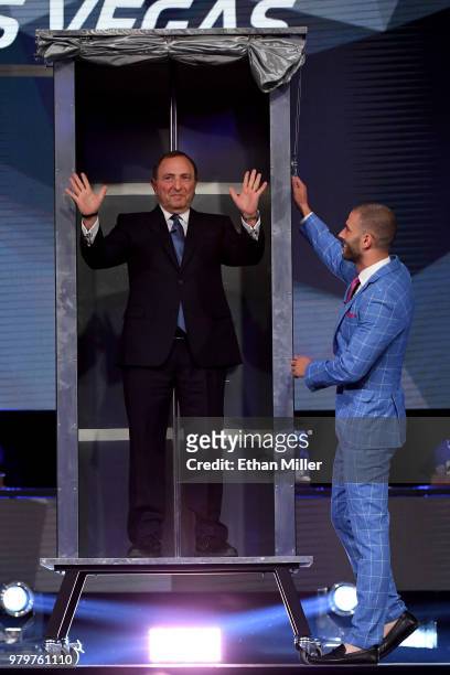 Commissioner Gary Bettman helps illusionist Darcy Oake perform a magic trick onstage at the 2018 NHL Awards presented by Hulu at The Joint inside the...