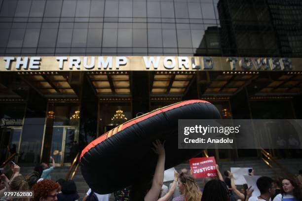 Person carries a boat, of a type which is used by refugees, during a rally against immigration policies in the United States on World Refugee Day in...