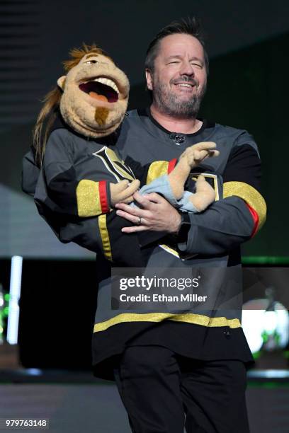 Comic ventriloquist and impressionist Terry Fator performs with his puppet Duggie Scott Walker as he presents an award at the 2018 NHL Awards...