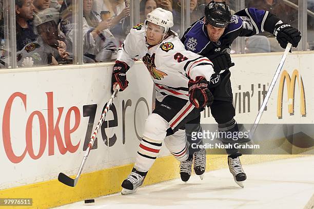 Jarret Stoll of the Los Angeles Kings fights for the puck alongside the boards against Duncan Keith of the Chicago Blackhawks during the game on...