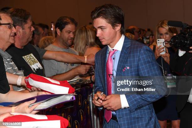Clayton Keller of the Arizona Coyotes signs autographs for fans as he arrives at the 2018 NHL Awards presented by Hulu at the Hard Rock Hotel &...