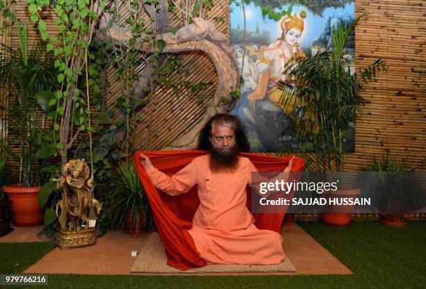 This picture taken on June 17 shows Indian spiritual leader Swami Chidanand Saraswati speaking with an AFP reporter during an interview at his ashram...