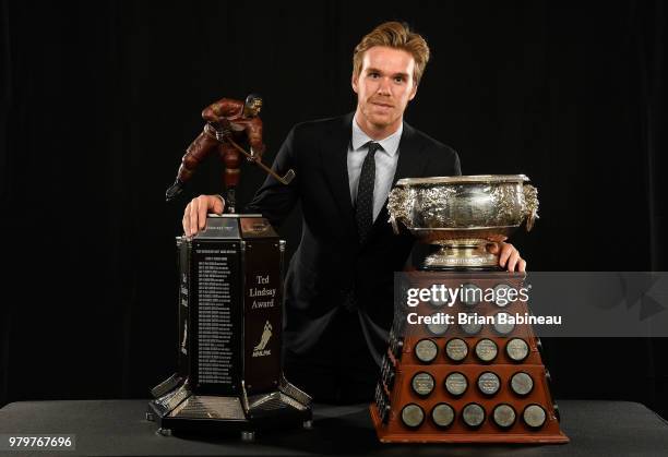 Connor McDavid of the Edmonton Oilers poses for a portrait with the Art Ross Trophy and the Ted Lindsay Award at the 2018 NHL Awards at the Hard Rock...