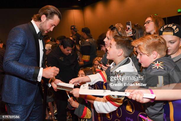 Victor Hedman of the Tampa Bay Lightning signs autographs for fans as he arrives at the 2018 NHL Awards presented by Hulu at the Hard Rock Hotel &...