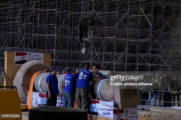 Dpatop - Members of the Grand Egyptian Museum Conservation Centre inspect the column of ancient Egyptian Pharaoh King Merenptah after being...