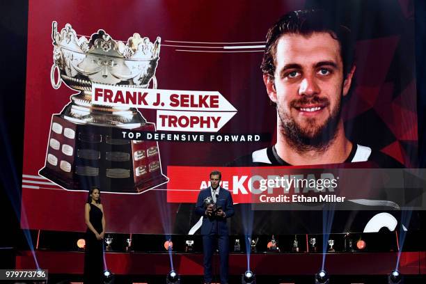 Anze Kopitar of the Los Angeles Kings accepts the Frank J. Selke trophy, given to the top defensive forward, onstage at the 2018 NHL Awards presented...