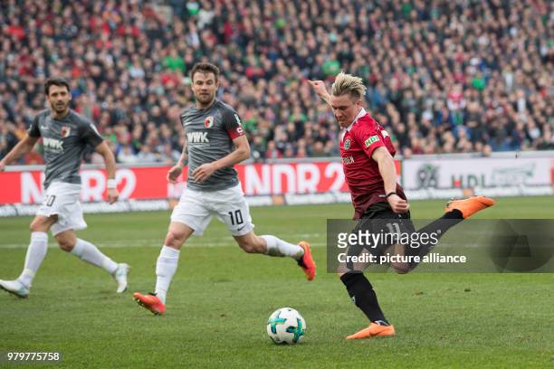 March 2018, Hanover, Germany: Bundesliga football, Hannover 96 vs FC Augsburg at the HDI-Arena. Hannover's Felix Klaus in action against Augsburg's...